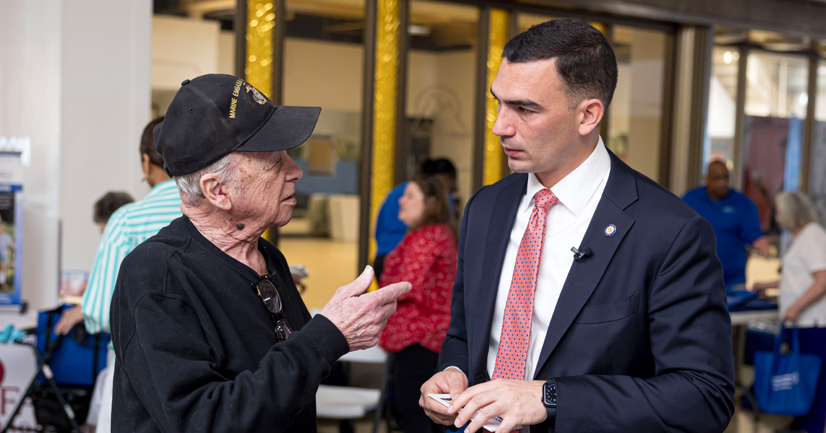 Senator Nick Miller speaking with a constituent.
